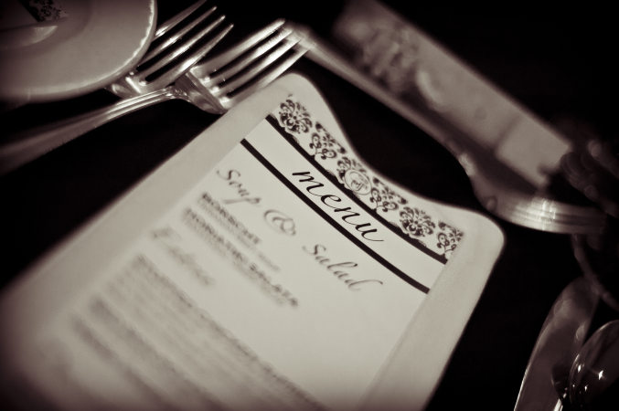 London Ukrainian Centre catering. Table set for wedding party dinner. A menu and silverware detail.